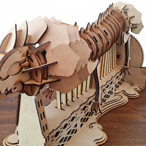 Laser cut dragon automaton model includes assembly manual in Spanish and English image 3