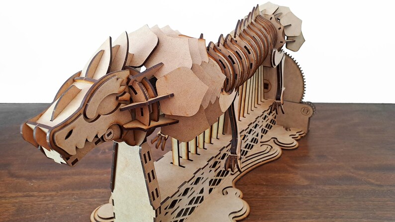 Laser cut dragon automaton model includes assembly manual in Spanish and English image 3