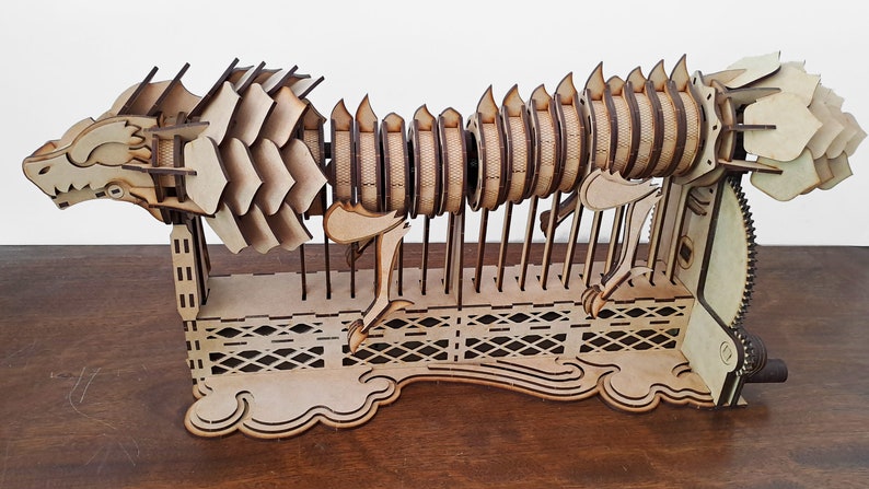 Laser cut dragon automaton model includes assembly manual in Spanish and English image 4