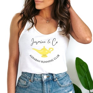 May include: White tank top with a yellow genie lamp graphic and the text "Jasmine & Co Agrabah Running Club".