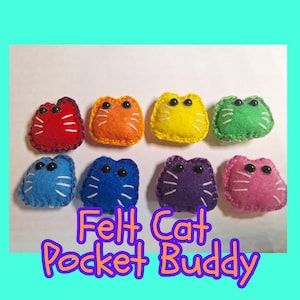 May include: Eight colorful felt cat pocket buddies. Each cat is a different color, including red, orange, yellow, green, blue, purple, and pink. They have white stitched details and black button eyes. The text "Felt Cat Pocket Buddy" is below the cats.