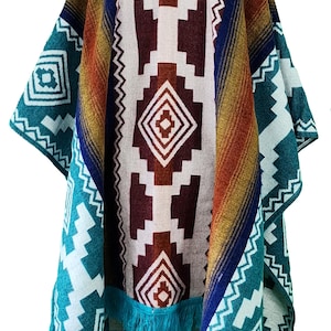 May include: A colorful poncho with a geometric pattern in shades of blue, green, white, brown, and orange. The poncho has a fringe border and a zipper closure at the neck.