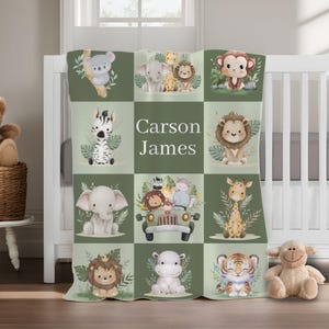 May include: A green and white baby blanket with a jungle animal theme. The blanket features a variety of animals, including a zebra, elephant, lion, monkey, and hippopotamus. The blanket also includes the name "Carson James" in a white font.
