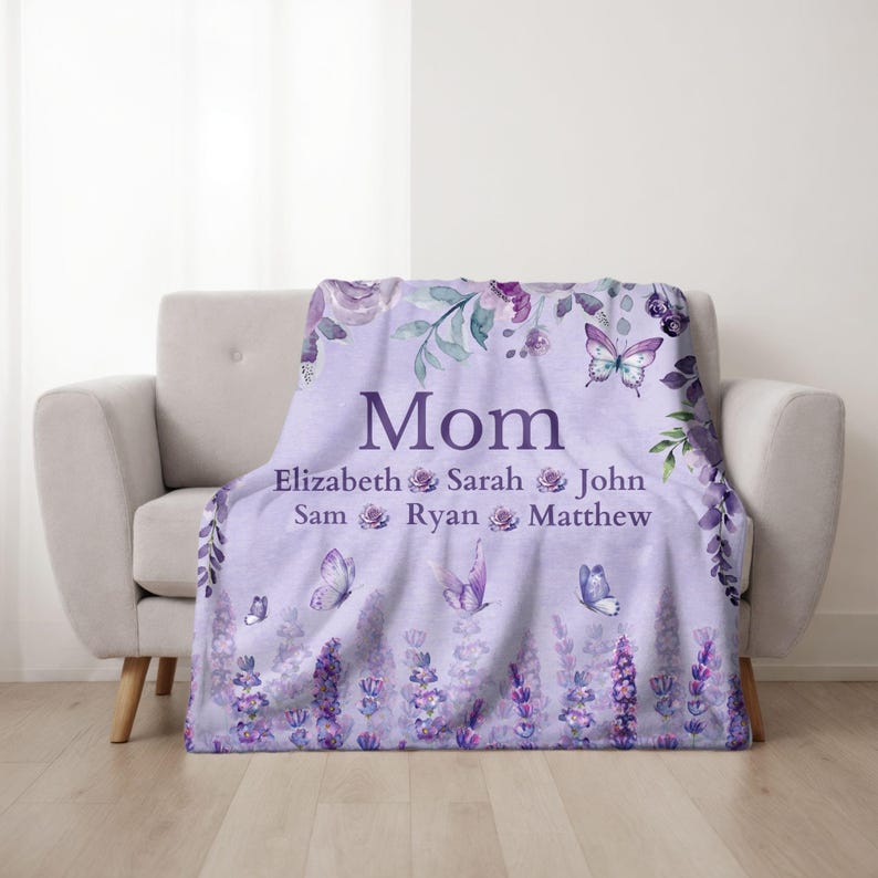 May include: A lavender throw blanket with the word "Mom" and names Elizabeth, Sarah, John, Sam, Ryan, and Matthew. The blanket features floral and butterfly designs in shades of purple and green.