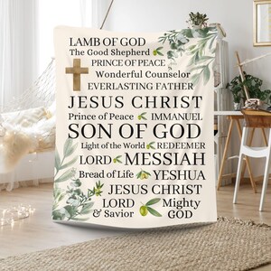 May include: A white tapestry with green foliage and olive branches. The tapestry features the text "LAMB OF GOD", "The Good Shepherd", "PRINCE OF PEACE", "Wonderful Counselor", "EVERLASTING FATHER", "JESUS CHRIST", "Prince of Peace", "IMMANUEL", "SON OF GOD", "Light of the World", "REDEEMER", "LORD", "MESSIAH", "Bread of Life", "YESHUA", "JESUS CHRIST", "LORD", "& Savior", "Mighty", "GOD".