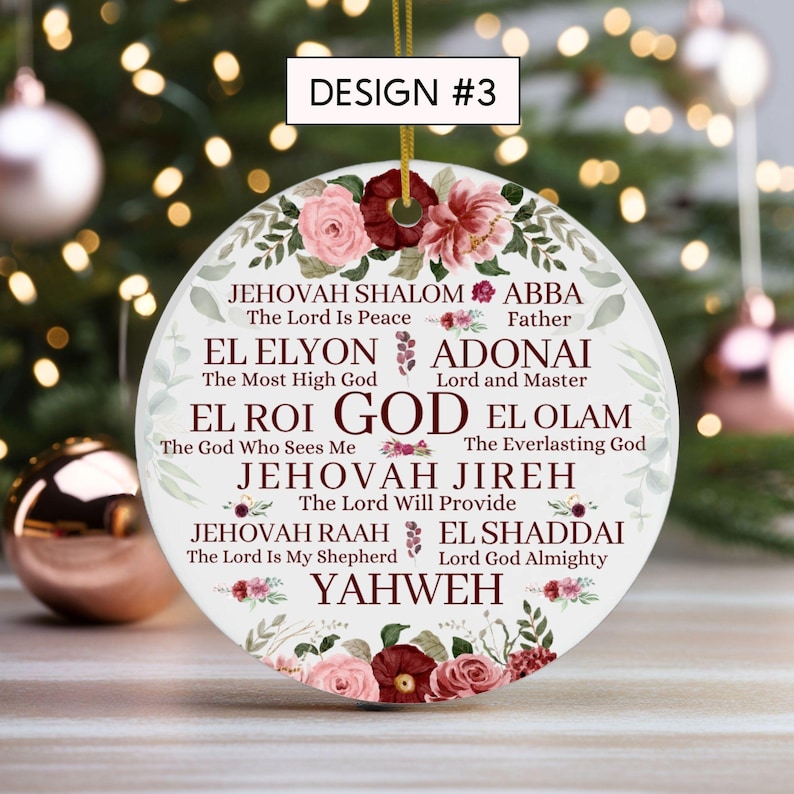 May include: A round white ceramic ornament featuring a floral border of pink and dark red roses. The text includes DESIGN #3, GOD, and various names for God such as JEHOVAH SHALOM, ABBA, EL ELYON, ADONAI, EL ROI, EL OLAM, JEHOVAH JIREH, JEHOVAH RAAH, EL SHADDAI, and YAHWEH.