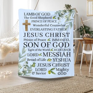 May include: A blue and white tapestry with a floral design and text that reads "Lamb of God, The Good Shepherd, Prince of Peace, Wonderful Counselor, Everlasting Father, Jesus Christ, Prince of Peace, Immanuel, Son of God, Light of the World, Redeemer, Lord, Messiah, Bread of Life, Yeshua, Jesus Christ, Lord, Mighty, & Savior, God".