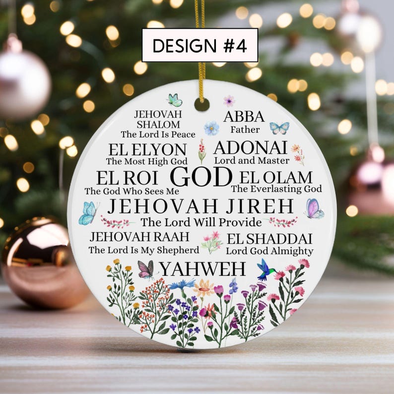 May include: A round white ceramic ornament featuring the text DESIGN #4 at the top. The surface displays various names of God in black lettering, including Jehovah Shalom, El Roi, and Yahweh, surrounded by colorful floral illustrations and butterflies.