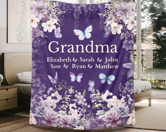 May include: A purple blanket with the word "Grandma" in white, surrounded by floral and butterfly designs. The names Elizabeth, Sarah, John, Sam, Ryan, and Matthew are listed below the word "Grandma".