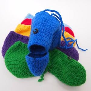 May include: A set of crocheted pouches in a rainbow of colors, including blue, green, purple, yellow, red, and light blue. Each pouch has a black button and a drawstring.