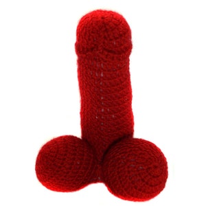 May include: A red crocheted plush toy shaped like a human male anatomy.