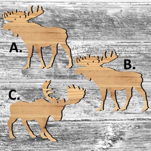 May include: Three wooden moose silhouettes, labeled A, B, and C, are arranged on a whitewashed wood background. The moose are cutouts with a simple design.