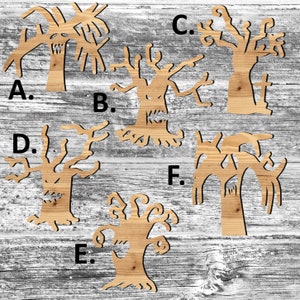 May include: Six wooden cutout spooky tree shapes with letters A through F labeling each tree. The trees are all different shapes and sizes, with gnarled branches and spooky faces.