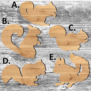 May include: Five wooden cutout squirrel shapes on a woodgrain background. The squirrels are labeled A through E.