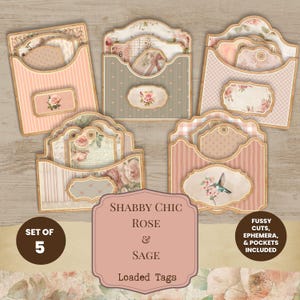 May include: A set of five decorative paper pockets containing assorted tags and ephemera with floral rose and hummingbird motifs in shades of pink, sage green, and cream. The text reads: SET OF 5, SHABBY CHIC ROSE & SAGE LOADED TAGS, FUSSY CUTS, EPHEMERA, & POCKETS INCLUDED.