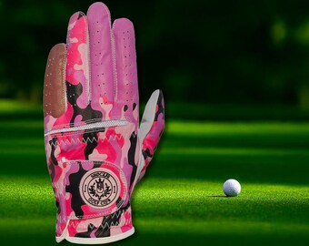 May include: Pink and black camouflage golf glove with a white logo that says "Shocker Golf Club".
