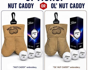 May include: A tan fabric golf ball pouch with a black clip, featuring embroidered text reading NUT CADDY or OL' NUT CADDY above a golf ball graphic. Each set includes three white golf balls labeled Titties 69 and a black box with Titties 69 branding.