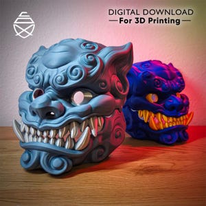 Puede incluir: Dos máscaras detalladas, azules y moradas, impresas en 3D con expresiones feroces. Las máscaras tienen dientes afilados y diseños intrincados en espiral. El texto en la parte superior dice "DESCARGA DIGITAL - Para impresión 3D".