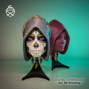 May include: Two Day of the Dead skull sculptures with hoods, one painted with a sugar skull design and the other in a solid maroon colour. The sculptures are on black stands against a teal background. Text reads "DIGITAL DOWNLOAD - For 3D Printing".