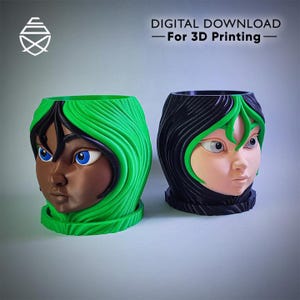 May include: Two decorative planters, each shaped like a stylized face. One has a dark complexion with green hair, the other has a light complexion with black hair. The planters are designed for 3D printing and feature the text "DIGITAL DOWNLOAD - For 3D Printing".