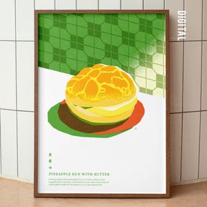 May include: A framed print featuring a colorful illustration of a pineapple bun with butter. The bun is yellow and orange, set against a green and white geometric background. The text "PINEAPPLE BUN WITH BUTTER" is visible.