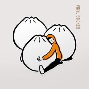 May include: Vinyl sticker showing a cartoon person in an orange hoodie embracing three large white dumplings. The dumplings have black outlines and the text "VINYL STICKER" is printed vertically.