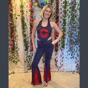 May include: Navy blue halter top and matching pants set. The top features a large red sequin circle. The pants have flared legs with red sequin panels. The set is a stylish, eye-catching outfit.