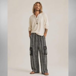May include: A long-sleeve cream-colored henley shirt with a button-up neckline paired with loose-fitting, wide-leg cargo pants featuring a vertical black and white striped pattern, side pockets, and a small white lightning bolt graphic on each pocket.