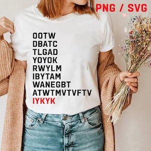 May include: White t-shirt with black text and the red text "IYKYK". The shirt has a crew neck and short sleeves. The text is arranged vertically and includes abbreviations and acronyms. The shirt is paired with blue jeans.