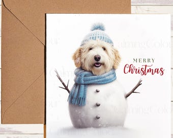 May include: A Christmas card featuring a dog dressed as a snowman. The dog wears a blue hat and scarf, with twig arms. The words "Merry Christmas" are written in red script. A brown envelope is on the left.