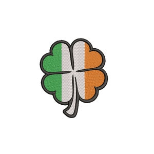 Puede incluir: Un trébol verde, blanco y naranja con un contorno negro. El trébol es un símbolo de Irlanda.