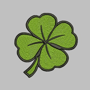 Op de afbeelding: Een groene klaver met vier bladeren en zwarte contouren. De klaver is een symbool van geluk en fortuin.