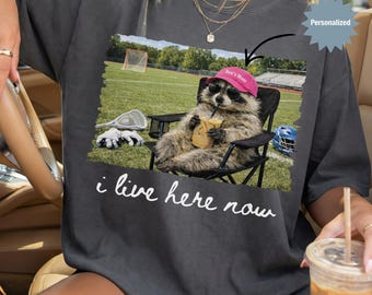 Personalized I Live Here Now Raccoon Lacrosse Mom Shirt, Custom Funny Raccoon LAX Mom T-Shirt