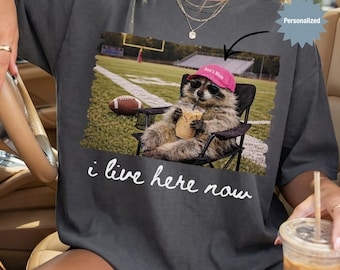 Personalized I Live Here Now Raccoon Football Mom Shirt, Custom Funny Raccoon Football Mom T-Shirt