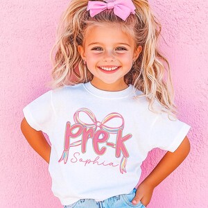 Custom Girl First Day of School Pre-K Shirt, Personalized Name Brushstroke Pre-Kindergarten Pink Bow Tee, Coquette Preschool Back to School