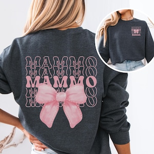 May include: A dark grey sweatshirt with a pink bow and the word "MAMMO" repeated in a retro style.
