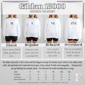 May include: White Gildan 18000 crewneck sweatshirt with size options M, L, XL, and 2XL. The image provides a size chart with measurements in inches for width, length, and sleeve length. The sweatshirt is 50% cotton and 50% polyester.