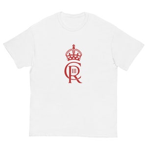 May include: White t-shirt with a red crown and the letters "C III R" printed on the front.