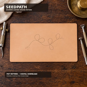 Peut inclure: Une pièce rectangulaire de cuir beige clair présentant un motif de gravure botanique à lignes fines, composé de tiges en boucle et de petits cercles. Le texte SEEDPATH BEGINNER LEATHER TOOLING PATTERN et PDF PATTERN / DIGITAL DOWNLOAD est visible.