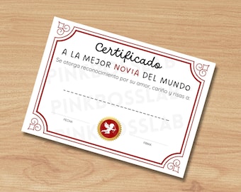 May include: A white certificate with a red border and decorative corner designs. The certificate has the words "Certificado A LA MEJOR NOVIA DEL MUNDO" in black text. A gold seal with a cupid is at the bottom.