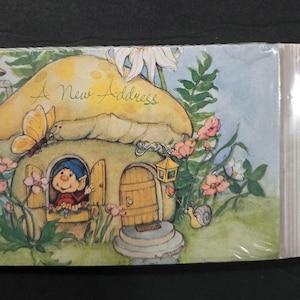 May include: A rectangular pack of new address announcement cards featuring a watercolor illustration of a yellow mushroom house with a small character in the window, a butterfly, flowers, and the text A New Address and NEW ADDRESS ANNOUNCEMENT.