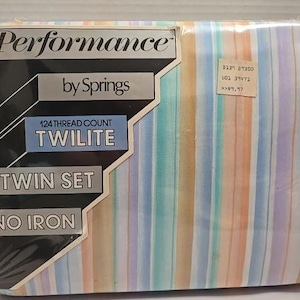 May include: A packaged twin set of Performance by Springs Twilite sheets. The package features a striped pattern in pastel colors, including orange, yellow, blue, and purple. The packaging includes the text "124 Thread Count", "Twin Set", and "No Iron".