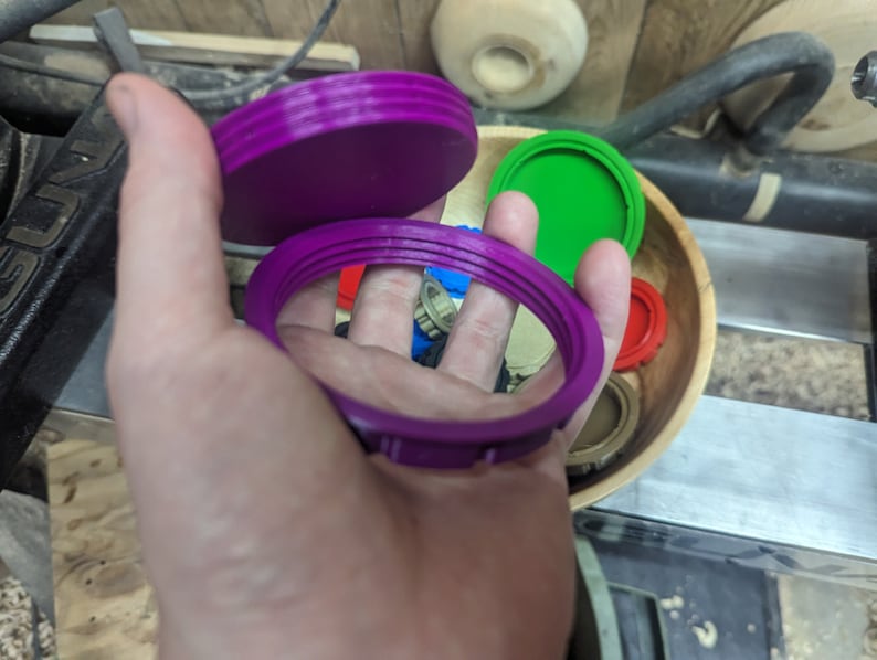 May include: A set of three purple plastic lids for jars. The lids are different sizes and have a ridged design.