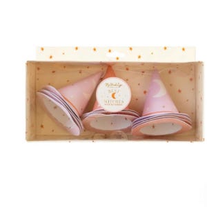 May include: A set of three pink and purple witch hats with gold stars and a crescent moon design. The hats are packaged in a box with a gold star pattern and the text "My Melody Best Witches with our smiles".