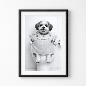 May include: Monochrome framed print featuring a dog on a toilet, engrossed in a newspaper labelled "Dog News Daily." The dog, a small breed with a black and white coat, wears a collar. The background is a tiled wall.