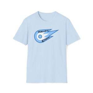 May include: Light blue t-shirt with a blue and white comet graphic and the text "Halley's Comet" printed on the front.
