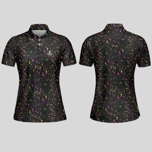 Front and back view of the black paint splatter polo shirt on a grey background.