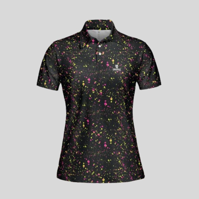 Front view of a black women's polo shirt with yellow and pink paint splatter pattern.
