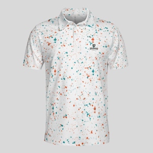 Front view of a white polo shirt with an all-over paint splatter pattern in orange and teal.