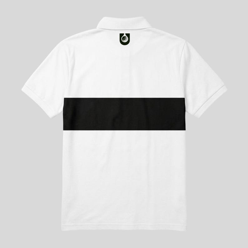Flat lay back view of a white men's golf polo with a black chest stripe and dark golf ball emblem below the collar.